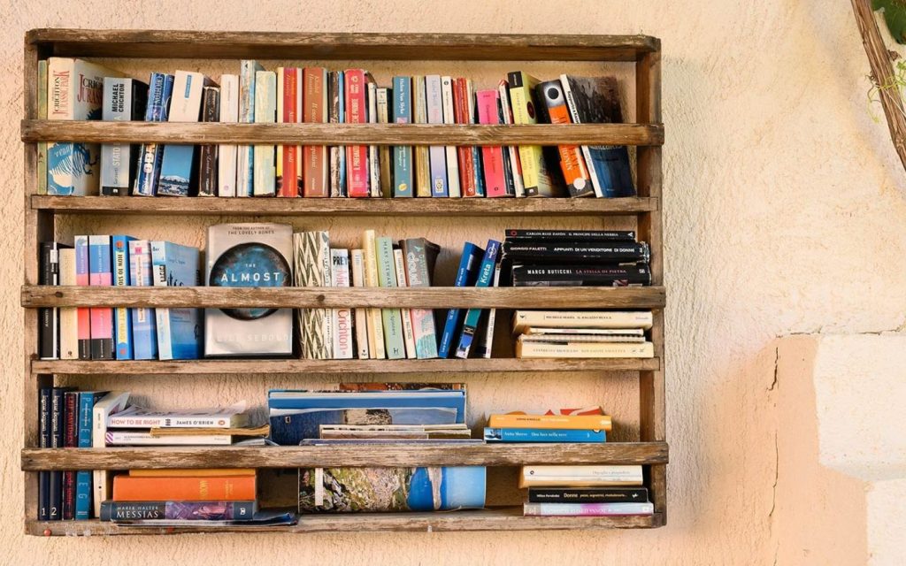 balcony décor ideas for apartments include adding a small bookshelf 