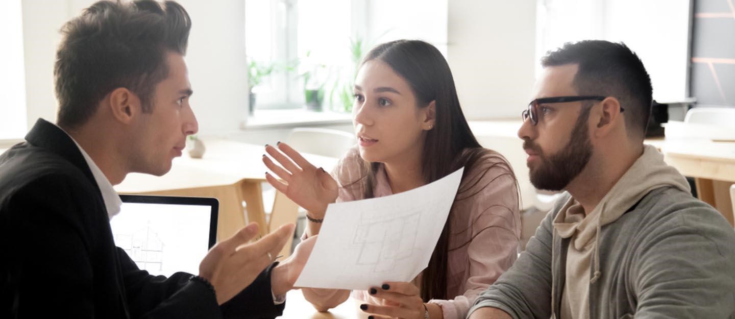 A couple discussing a rental property scams with a lawyer