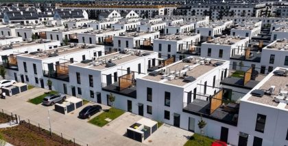 An aerial view of rows of attached modern villas and townhouses.