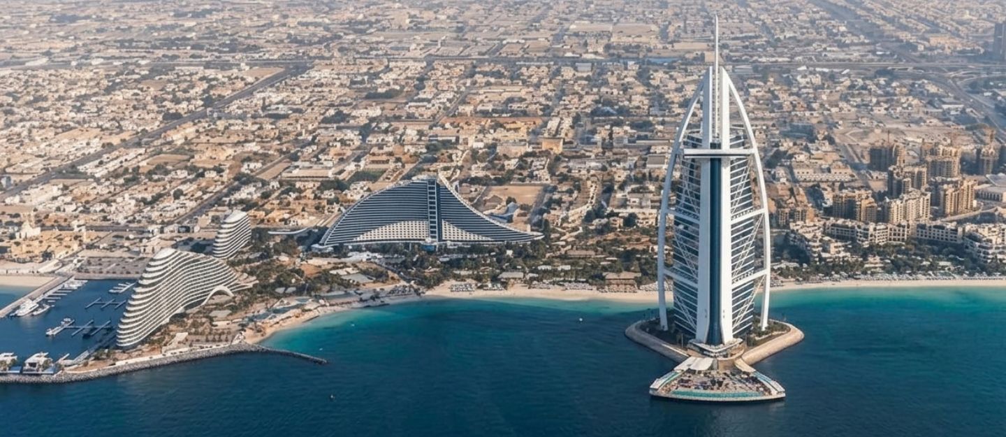 Aerial view of Dubai's sail-shaped Burj Al Arab hotel and city.