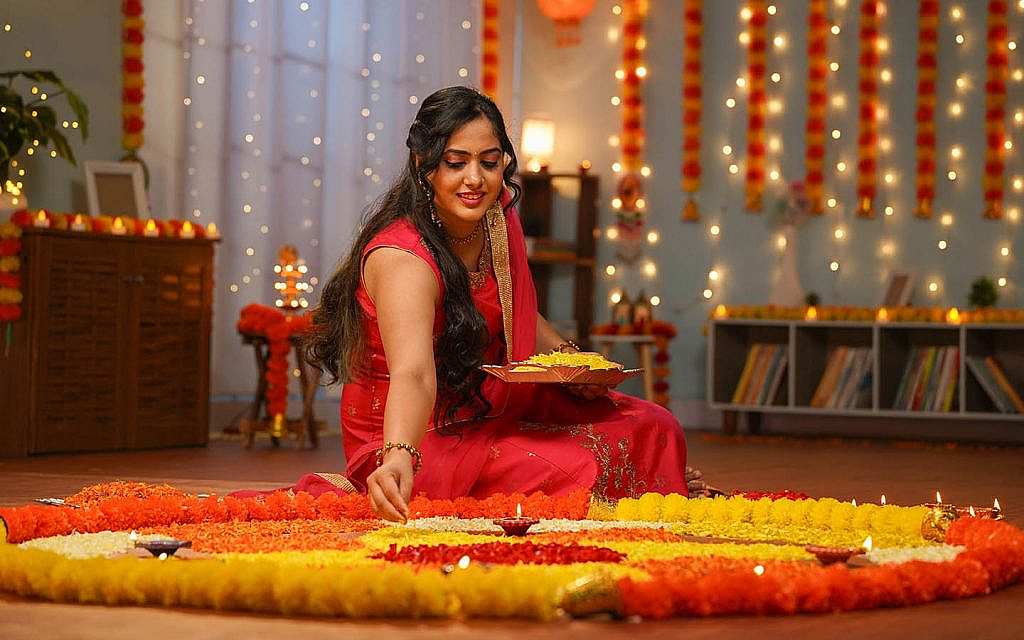 A woman making Rangoli for Diwali