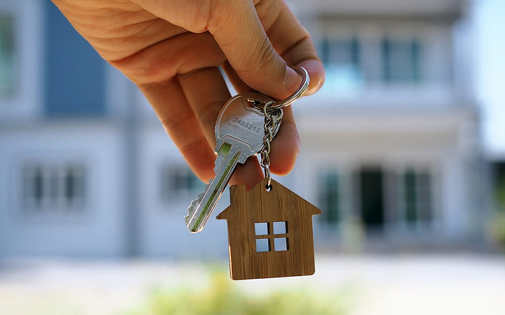 a man holding house keys