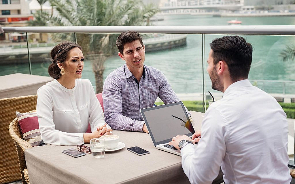 a client meeting in Dubai's outdoor cafe