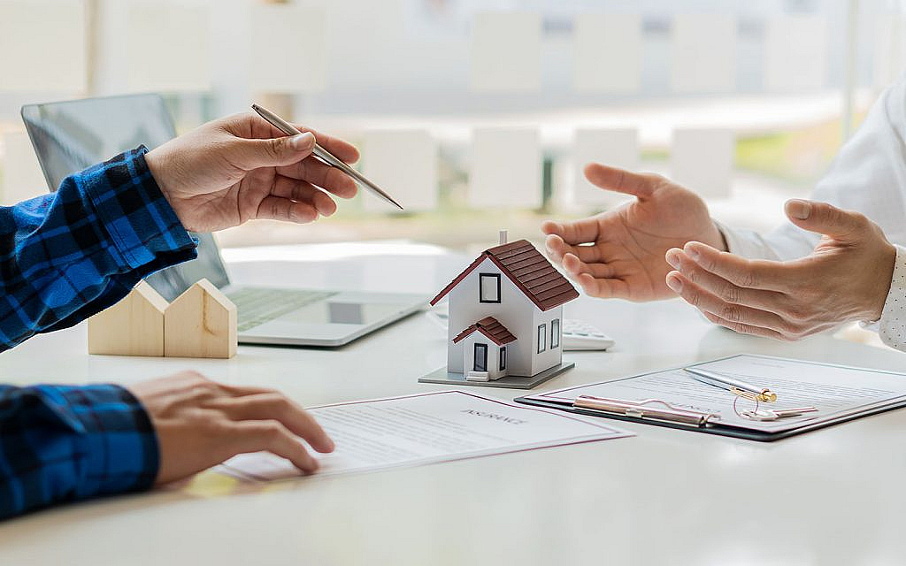 two men discussing a real estate transaction contract