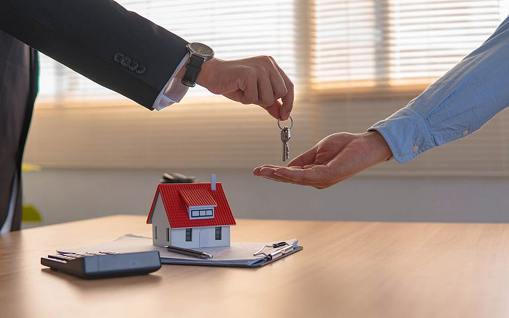 a man receiving keys of the divided property registered at DLD