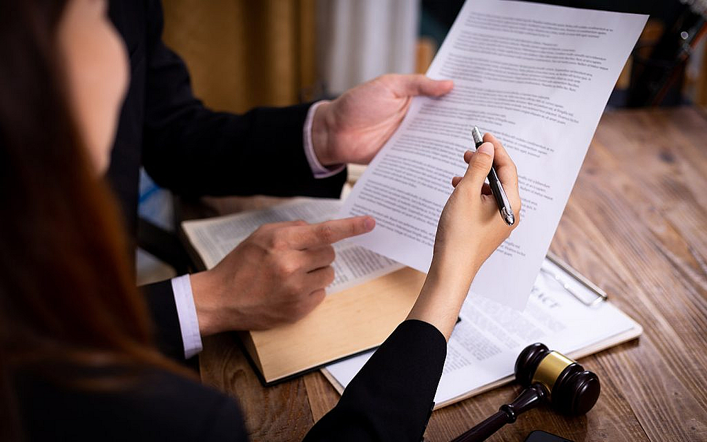 A women reading the laws before signing off-plan contract in dubai