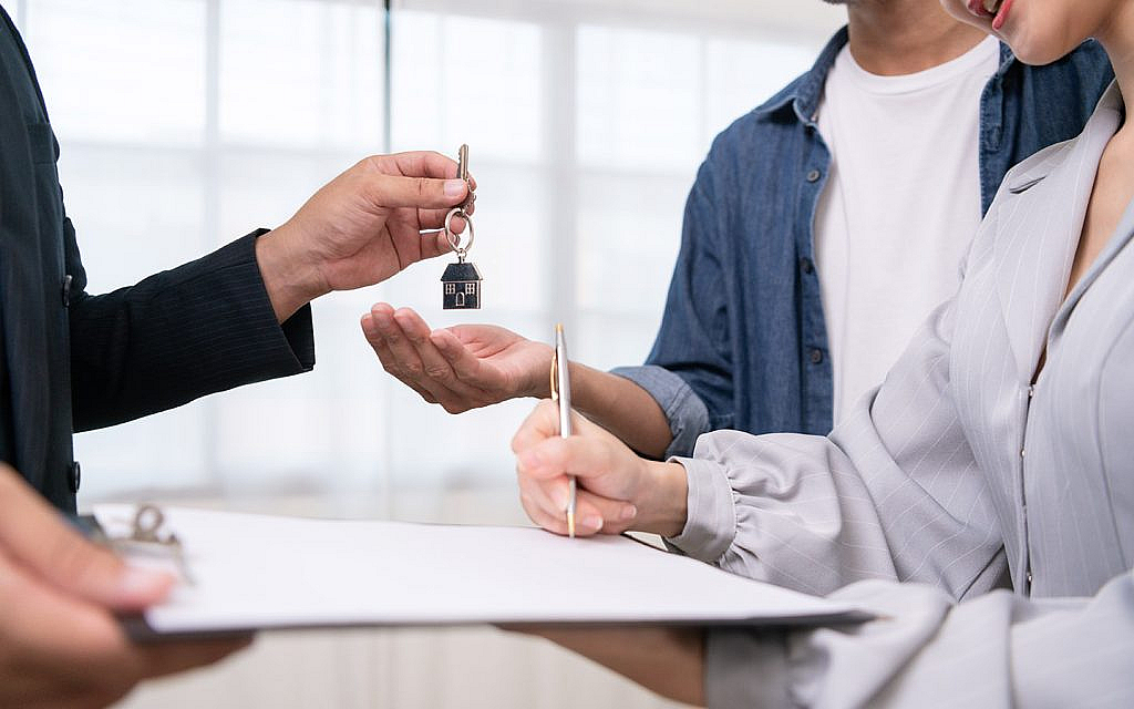 a couple signing leasehold ownership contract