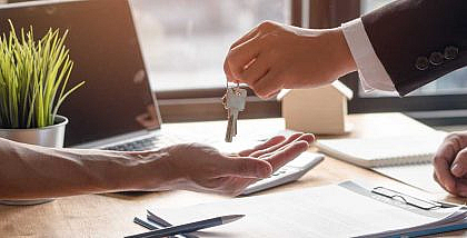 شخص يسلم مفتاح منزل إلى شخص آخر