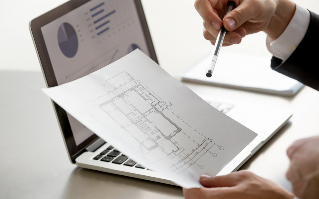pencil sketch of a real estate project infront of a laptop