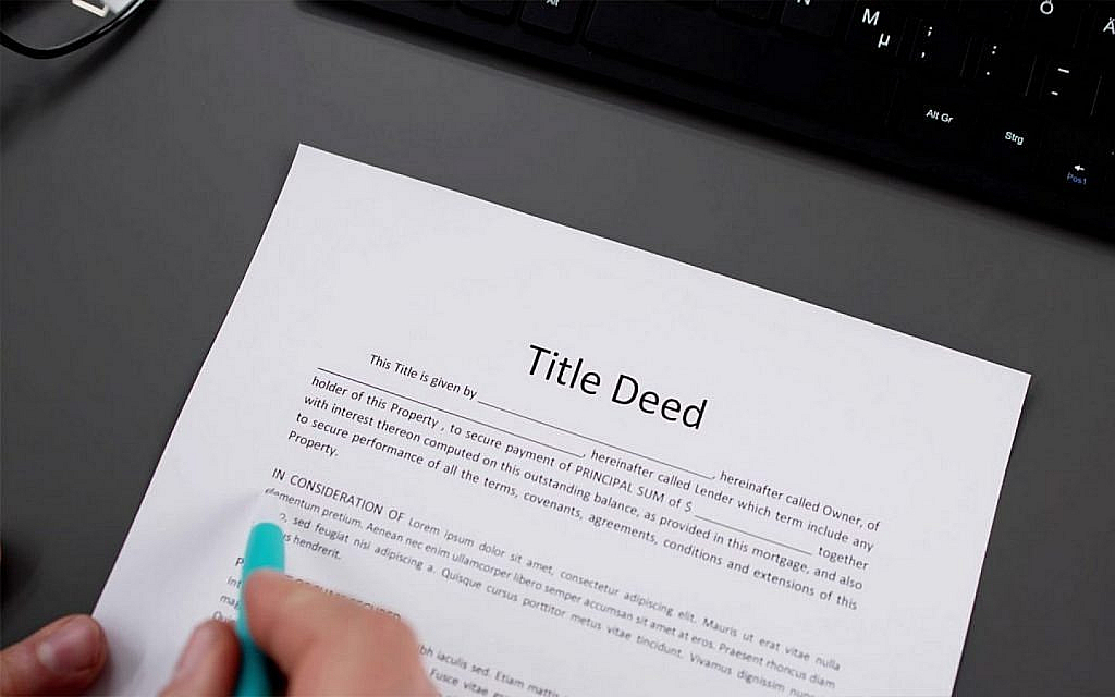 New house owner signing a title deed