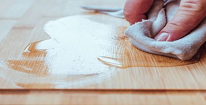 شخص يمسح غراء عن طاولة