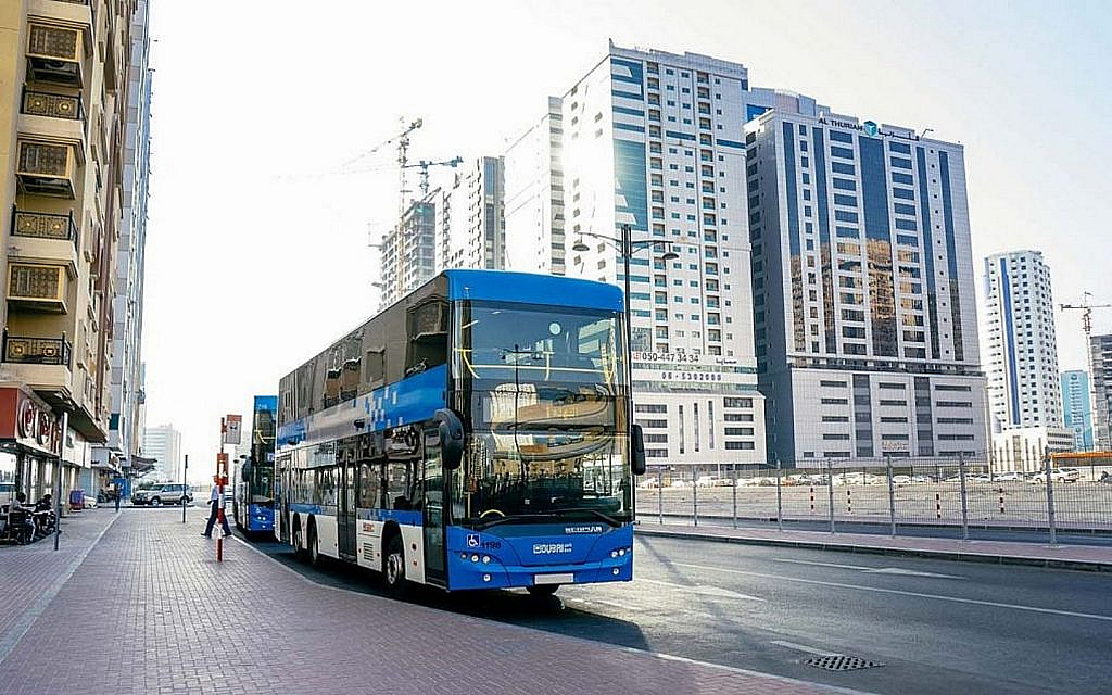 A blue color bus SRTA bus on the roads of Sharjah