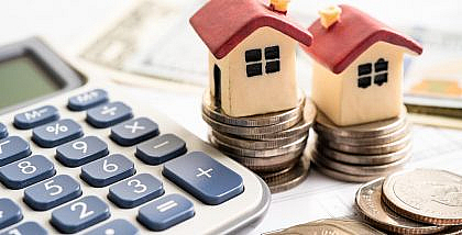 مجسمات منازل وآلة حاسبة وعملات نقدية