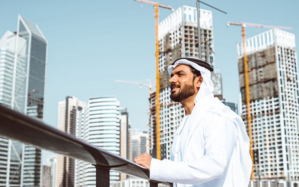 An Arab businessman look at Dubai's skyline. 