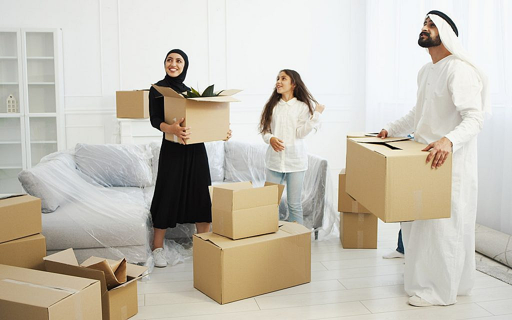 أب وأم وابنة يعملون على نقل الأثاث في كراتين