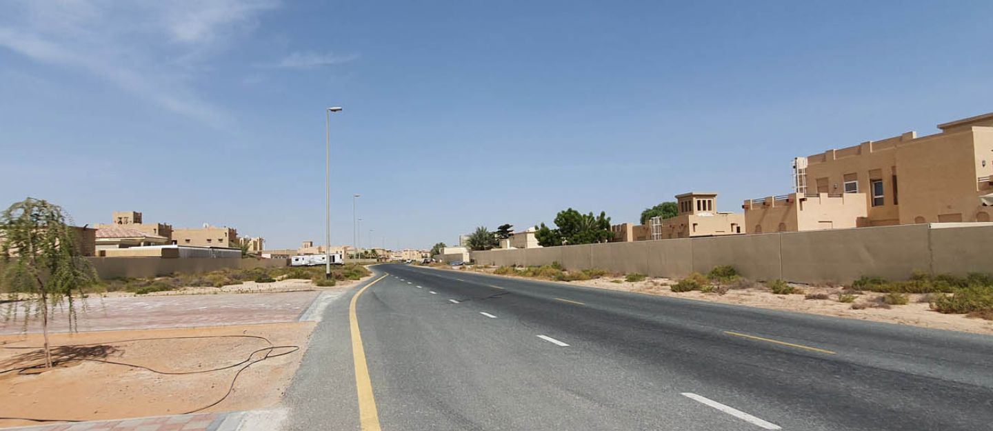 Street view of houses and desert landscape in Majan Dubai.