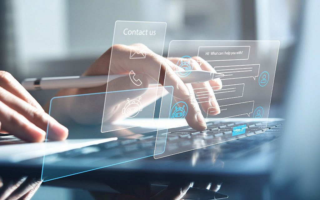 Hands typing on a keyboard with overlaid translucent screens showing 'Contact us' and a chat interface.