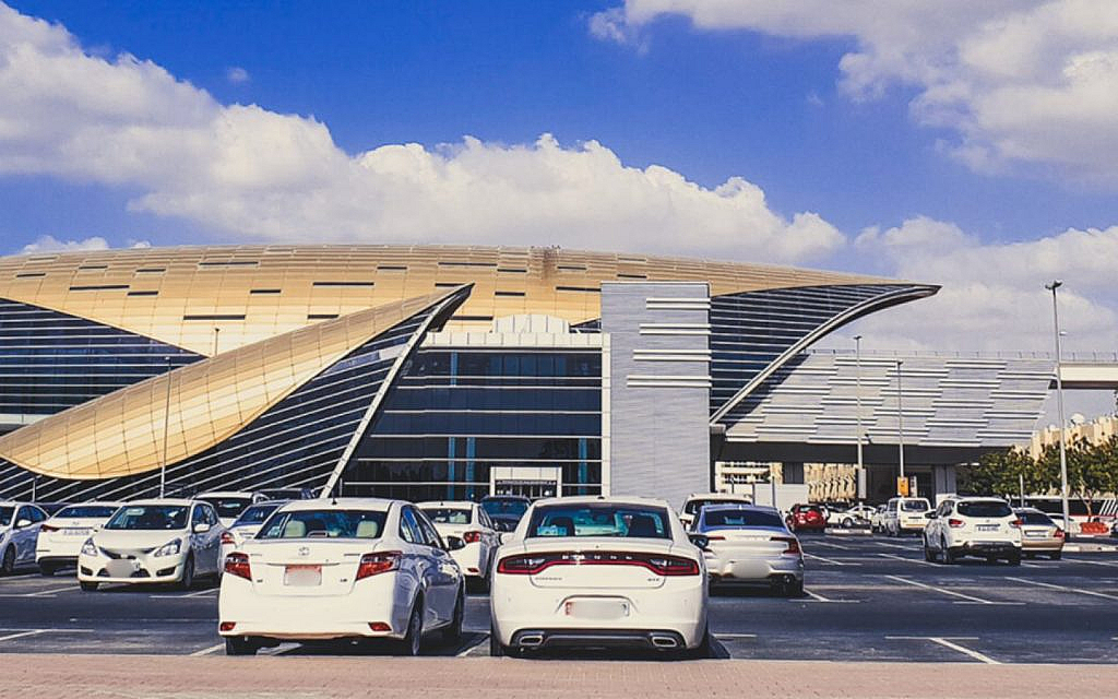 Vehicles parked outside a metro station near Al Qusais