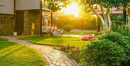 Lush garden with a path and flowers, maintained by Landscaping Companies in Sharjah.
