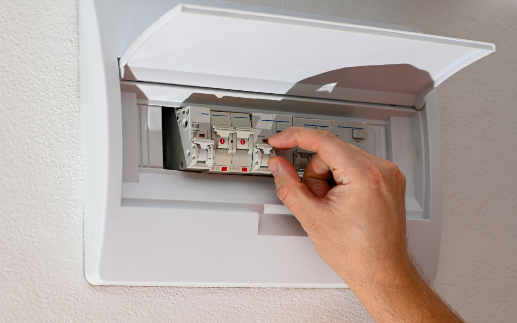 man adjusting electirical switches