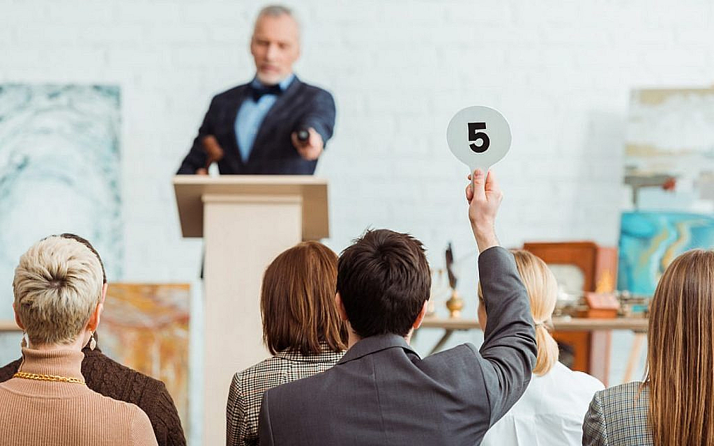 Person bidding for property auctions in Ajman
