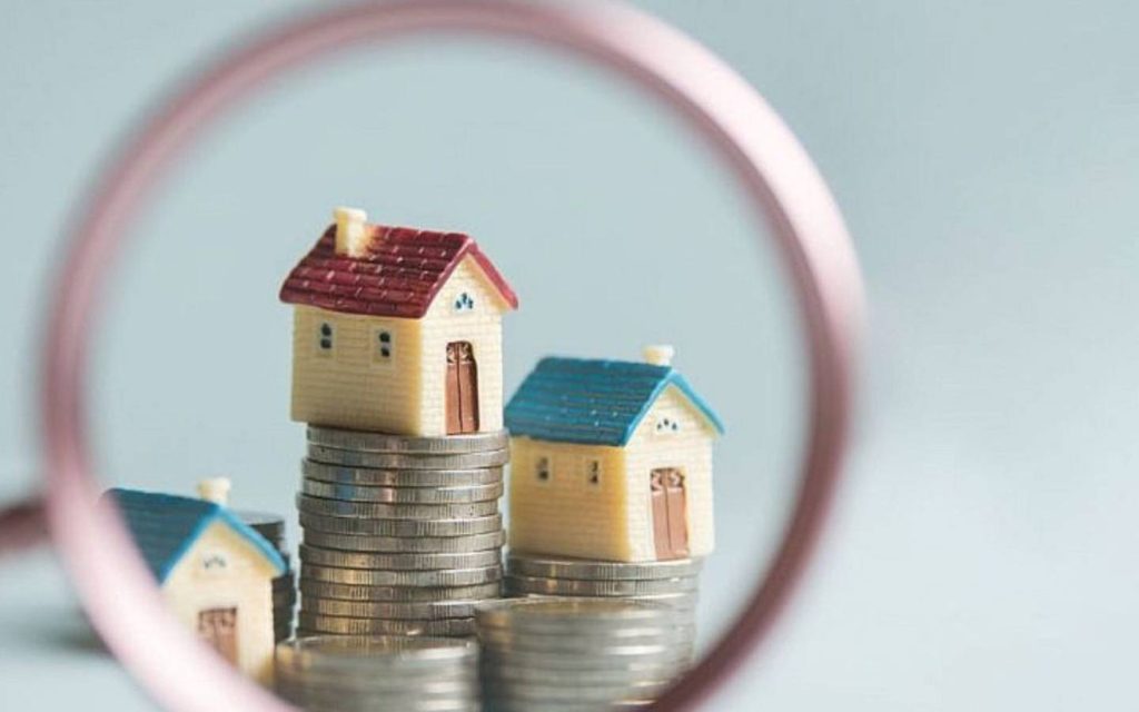 Miniature model houses viewed through a magnifying glass