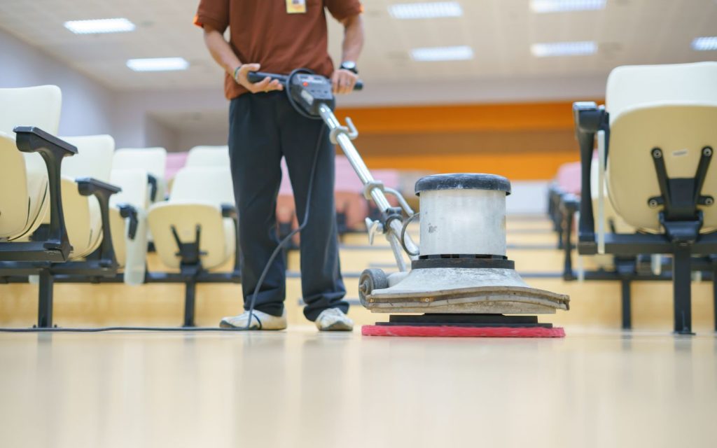a person from marble polishing company in Abu Dhabi is cleaning the floor