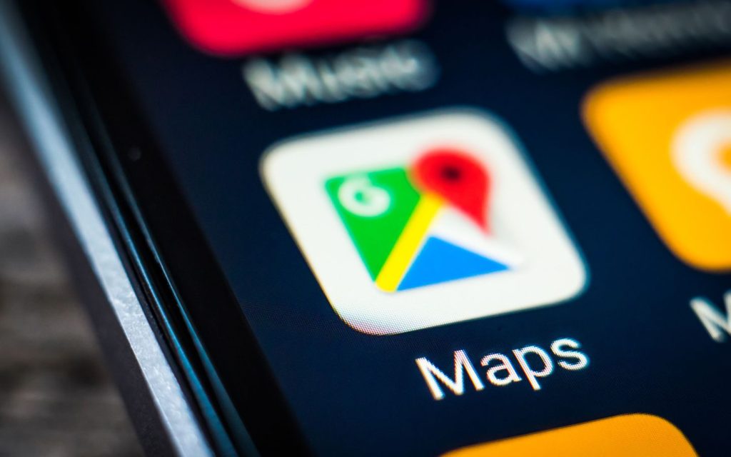 A mobile phone displaying Google Maps icon.
