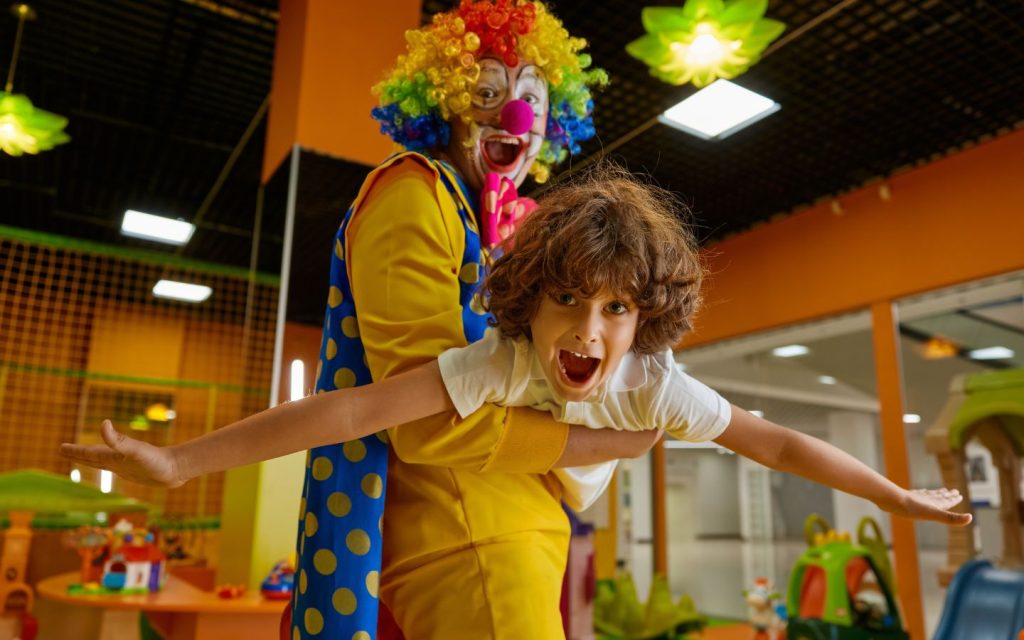 Clown entertaining a child at a birthday party 