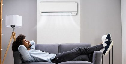 a person enjoying cool air after choosing between central AC vs split AC for UAE homes