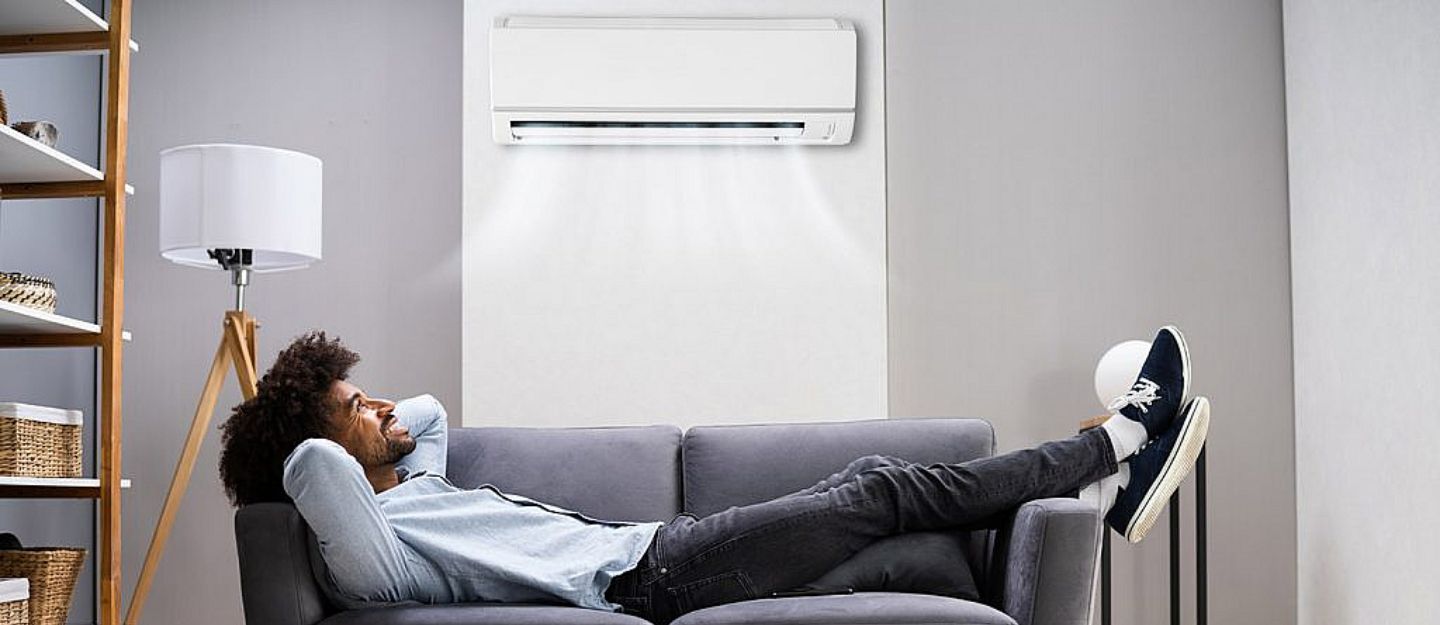 a person enjoying cool air after choosing between central AC vs split AC for UAE homes