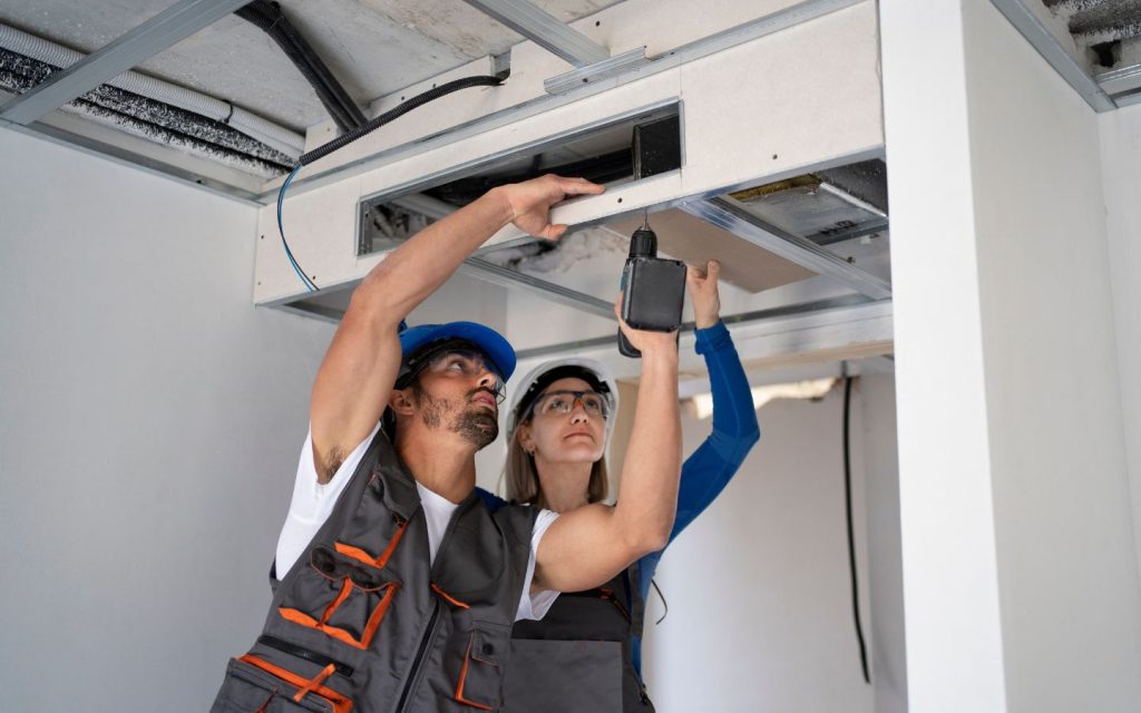 Workers maintaining the HVAC and ventilation system