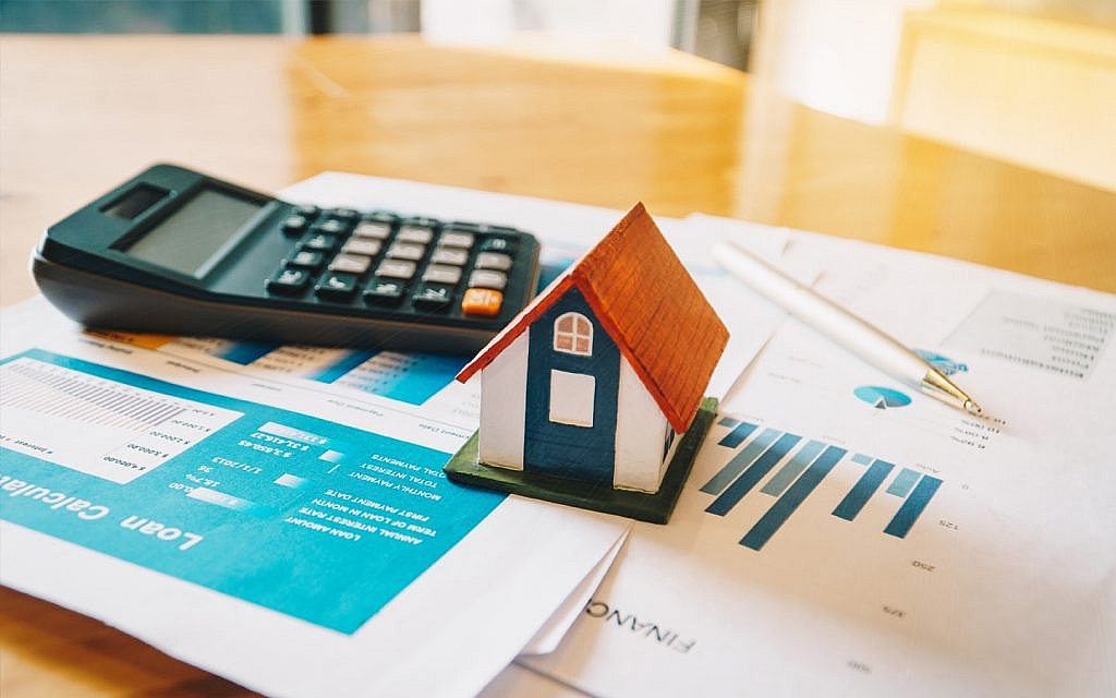property buying documents and calculator on the table