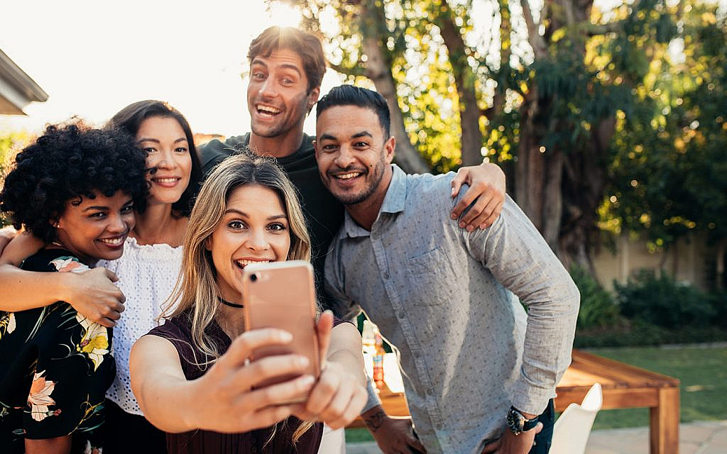 a group of friends taking picture at staycation
