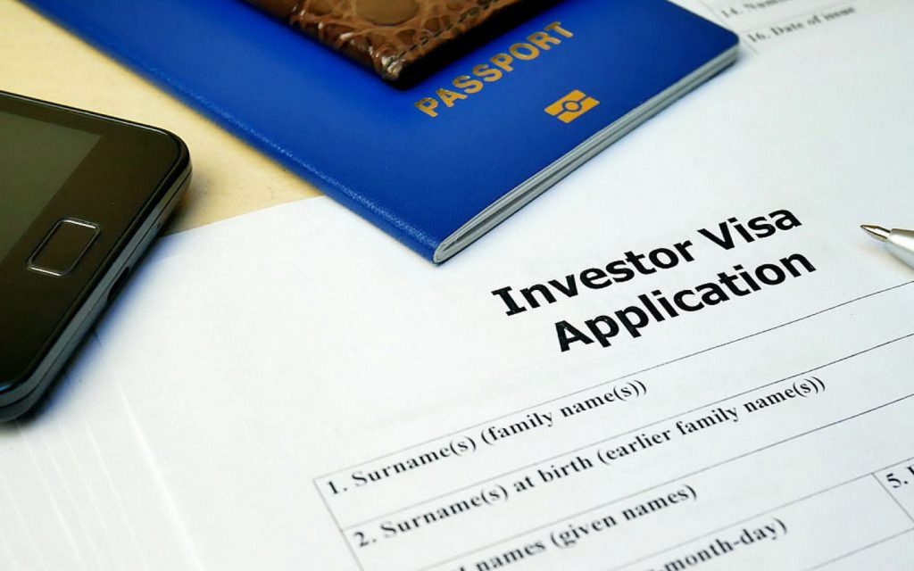 Investor visa application written on a white paper