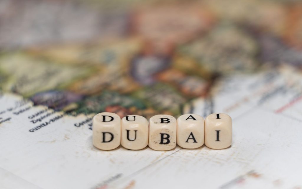 Wooden blocks of Dubai on world map
