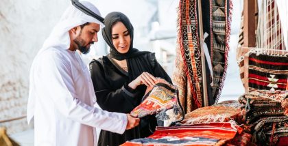 a couple is visiting carpet shops in sharjah