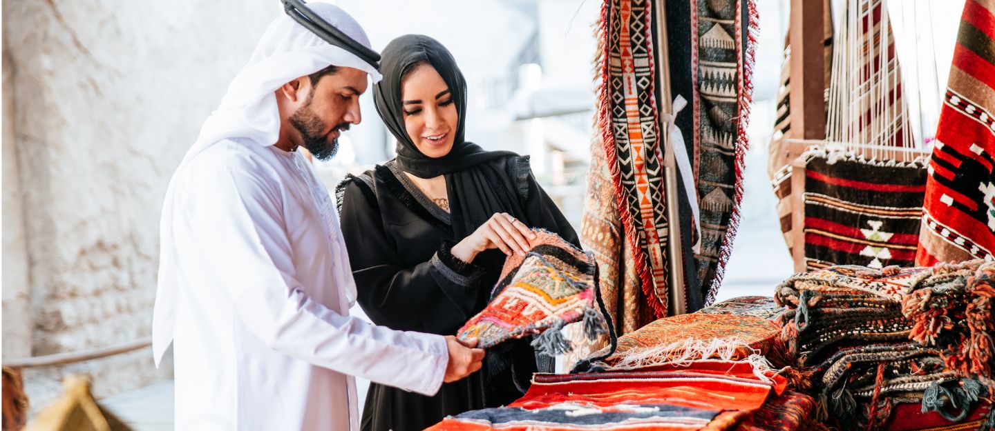 a couple is visiting carpet shops in sharjah